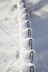 Image showing metal fence with snow