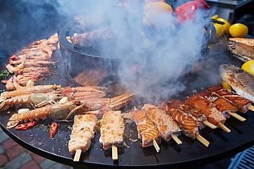 Image showing Grilled fresh seafood: prawns, fish, octopus, oysters food background Barbecue Cooking BBQ
