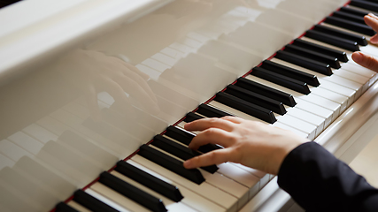 Image showing Womans hands on the keyboard of the piano closeup