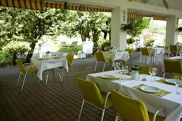 Image showing terrace summer cafe with tables and chairs for people, an empty institution for recreation, nobody