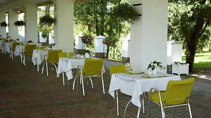 Image showing terrace summer cafe with tables and chairs for people, an empty institution for recreation, nobody