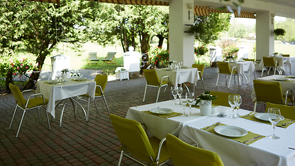 Image showing terrace summer cafe with tables and chairs for people, an empty institution for recreation, nobody