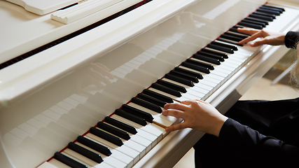 Image showing Womans hands on the keyboard of the piano closeup