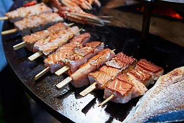 Image showing Grilled fresh seafood: prawns, fish, octopus, oysters food background Barbecue Cooking BBQ