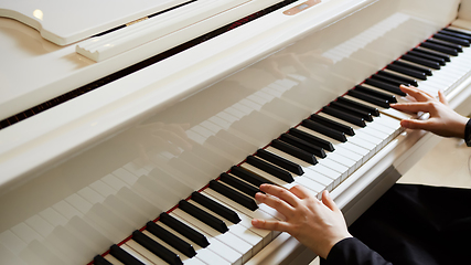 Image showing Womans hands on the keyboard of the piano closeup