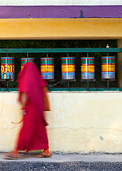 Image showing Buddhist monk rotating prayer wheels in McLeod Ganj