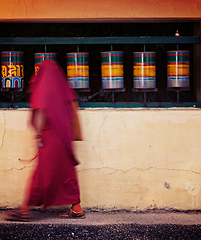 Image showing Buddhist monk spinning prayer wheels. McLeod Ganj