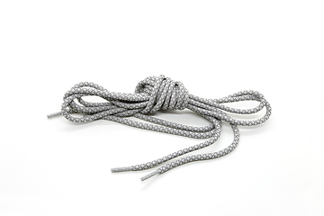 Image showing New shoelaces tied in a knot isolated on white background