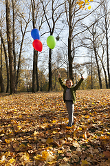 Image showing beautiful boy with a red, green and blue balloon