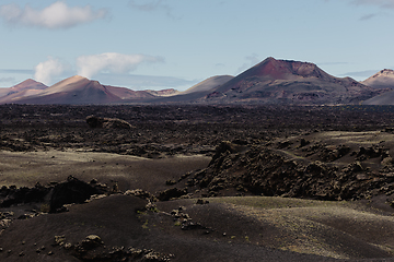 Image showing Black volcanic landscape of Timanfaya National Park in Lanzarote. Popular touristic attraction in Lanzarote island, Canary Islands, Spain.
