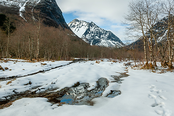 Image showing snowy mountain peak with snow reflecting in water in the foregro