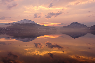 Image showing evening atmosphere with clouds reflecting in the sea