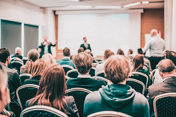 Image showing I have a question. Group of business people sitting in conference hall. Businessman raising his arm. Conference and Presentation. Business and Entrepreneurship