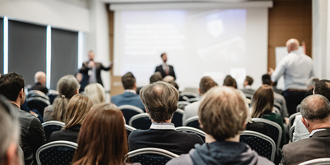 Image showing I have a question. Group of business people sitting in conference hall. Businessman raising his arm. Conference and Presentation. Business and Entrepreneurship