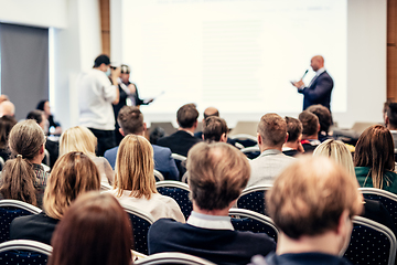 Image showing I have a question. Group of business people sitting in conference hall. Businessman raising his arm. Conference and Presentation. Business and Entrepreneurship