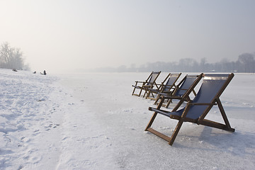 Image showing empty deckchairs on frozen lake