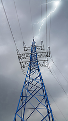 Image showing High voltage tower against the cloudy sky with lightning strike