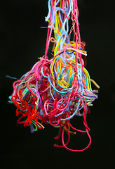 Image showing Multicolored tangled threads for needlework on black background