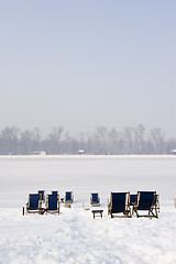 Image showing empty deckchairs on a frozen lake