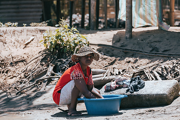 Image showing Malagasy woman washes laundry, Madagascar countryside