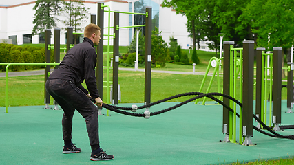 Image showing Men with battle rope battle ropes exercise in the street fitness gym.