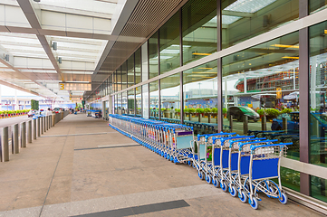 Image showing luggage carts by airport entrance