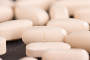 Image showing convex light-colored pills