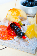 Image showing mix cold cut on a stone with fresh pears