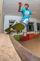 Image showing Skateboarder performing a pivot grind
