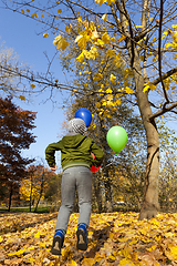 Image showing beautiful boy with a red, green and blue balloon