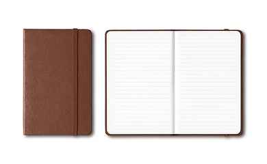 Image showing Dark leather closed and open lined notebooks isolated on white