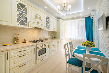 Image showing Beige, white and cyan furniture at kitchen in provence style,