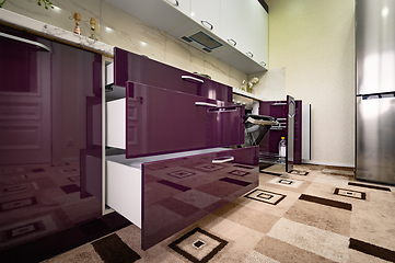 Image showing Purple and white modern kitchen furniture, front view