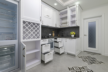 Image showing Open doors and drawers open at modern white kitchen