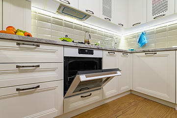 Image showing White kitchen in classic style, oven door is open