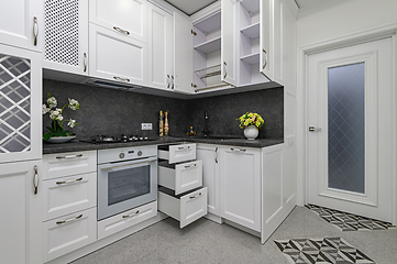 Image showing Open doors and drawers open at modern white kitchen