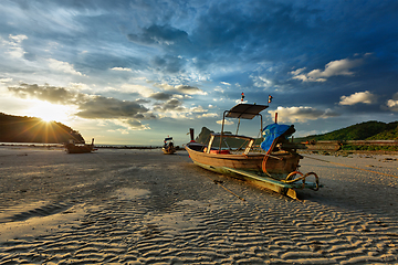 Image showing Long tail boat on beach on sunset