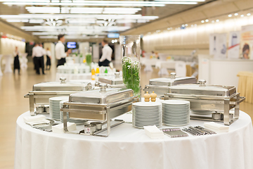 Image showing Waiters prepare buffet before a coffee break at business conference meeting.