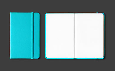 Image showing Aqua blue closed and open notebooks isolated on black