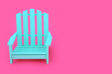 Image showing Alone Time with Wooden Blue Chair on Vivid Pink