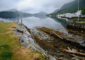 Image showing boat slip in the center of a small town with a reflection of the