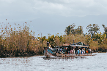 Image showing overloaded boat taxi in countryside on river