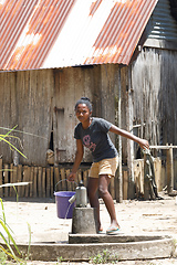 Image showing Malagasy girl goes for water to a public pump, Madagascar