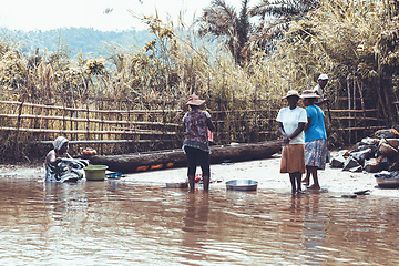 Image showing Malagasy woman washes laundry, Madagascar countryside