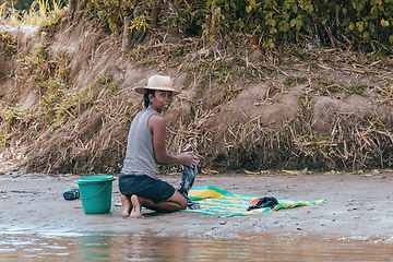 Image showing Malagasy woman washes laundry, Madagascar countryside