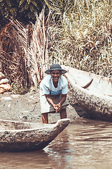 Image showing Malagasy woman washes dishes, Madagascar countryside