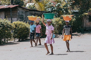 Image showing Malagasy woman carry heavy loads on head. Madagascar