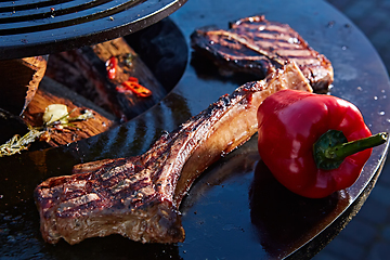 Image showing beautifully seared tomahawk steak, medium rare to rare