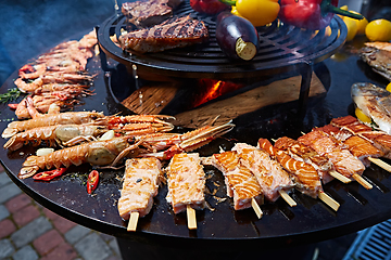 Image showing Grilled fresh seafood: prawns, fish, octopus, oysters food background Barbecue Cooking BBQ