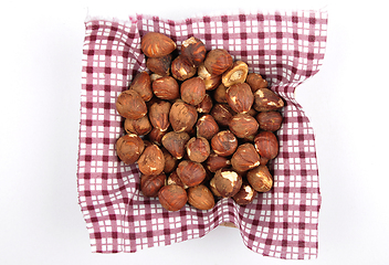 Image showing Hazelnuts on cloth in bamboo bowl 